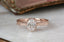 Lushly engraved gold cocoons around your choice of gemstone, while hidden diamonds are tucked below in this heirloom engagement ring setting crafted by The North Way Studio. This engraved ring is shown in 14 karat rose gold with an oval diamond center stone, viewed close up and facing the viewer.