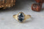 The Spire Signet ring by The North Way Studio, crafted from reclaimed 18k yellow gold and featuring a 2.41 carat natural fancy dark gray oval diamond. Hand-carved details with relic-like, organic leaf-inspired engravings and held by petite claw prongs. A timeless, mystical piece ready to ship.