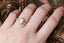 An elven inspired three stone leaf and diamond fantasy engagement ring in 14 karat yellow gold