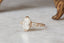 A nature inspired 14k yellow gold leaf and diamond fantasy engagement ring, ready to ship in lab grown oval diamond