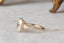 A ready to ship three stone leaf and diamond fantasy engagement ring in 14 karat yellow gold and lab grown oval diamond