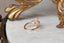 A ready to ship three stone leaf and diamond fantasy engagement ring in 14 karat yellow gold and lab grown oval diamond