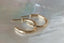 Everyday yellow gold hoop earrings with hand-carved leaves. 