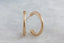 Everyday solid 14 karat yellow gold hoop earrings with hand-carved leaves and brushed finish meant to mimic antique earrings.