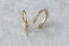 Everyday solid 10 karat yellow gold hoop earrings with hand-carved leaves and brushed finish meant to mimic antique earrings.
