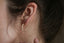 Everyday solid 10 karat yellow gold hoop earrings with hand-carved leaves and brushed finish meant to mimic antique earrings.