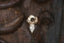 A small gold charm with lab grown diamond and hand-carved leaf details. 