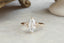 A customizable three diamond cluster and leaf prong engagement ring setting shown in lab grown marquise diamond and yellow gold