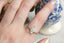 A customizable three diamond cluster and leaf prong engagement ring setting