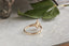 A three stone engagement ring in reclaimed yellow gold, lab grown marquise diamond, and natural pear cut diamonds