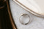 A solitaire fantasy engagement ring crafted by The North Way Studio. This fairytale ring features a lab grown marquise diamond, an engraved shield setting, and organic carvings in the gold on one side. Shown in 14 karat white gold. Shown viewed from above with the carved side up.