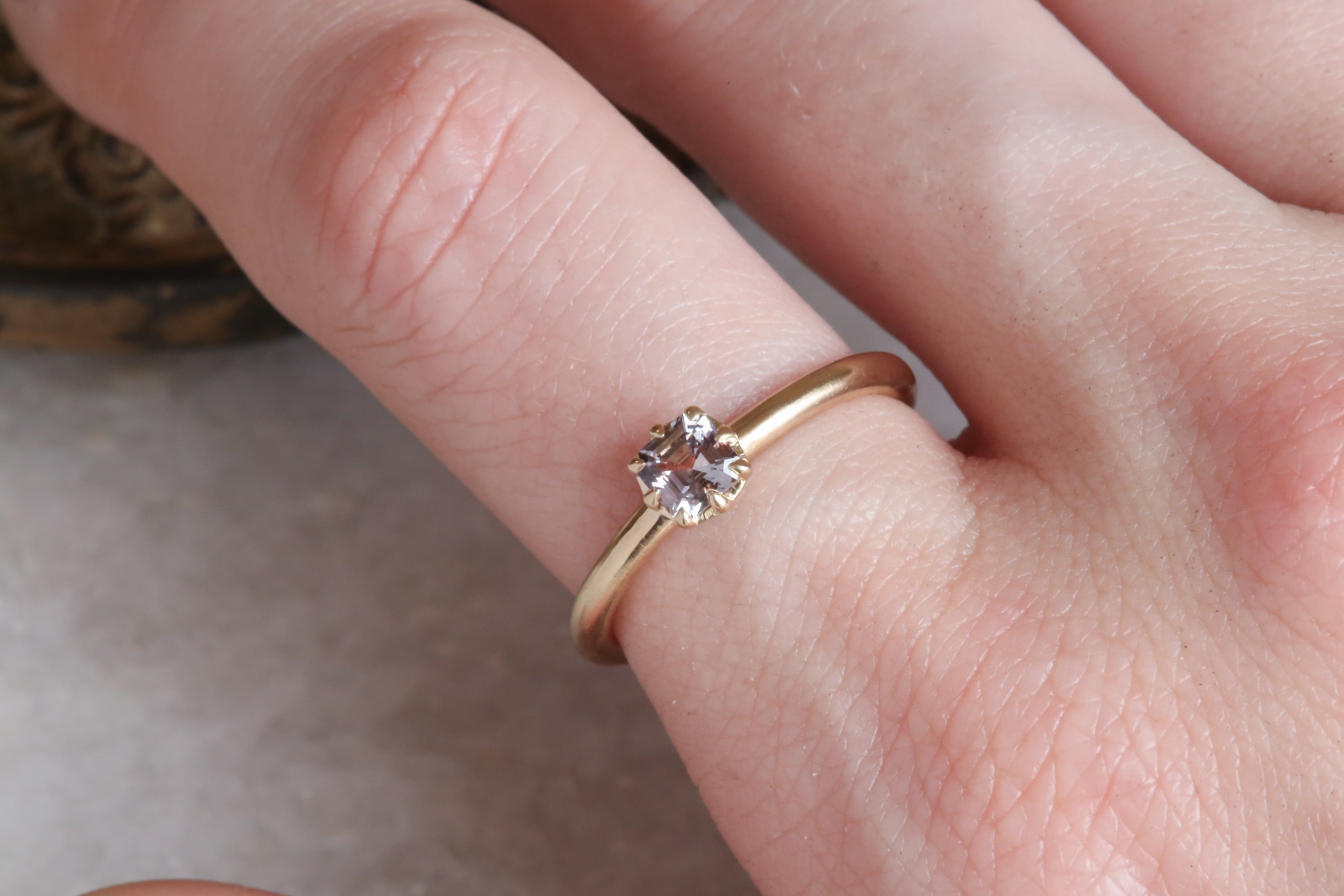 A solitaire ring inspired by antique collet settings in 14 karat yellow gold and natural Montana sapphire