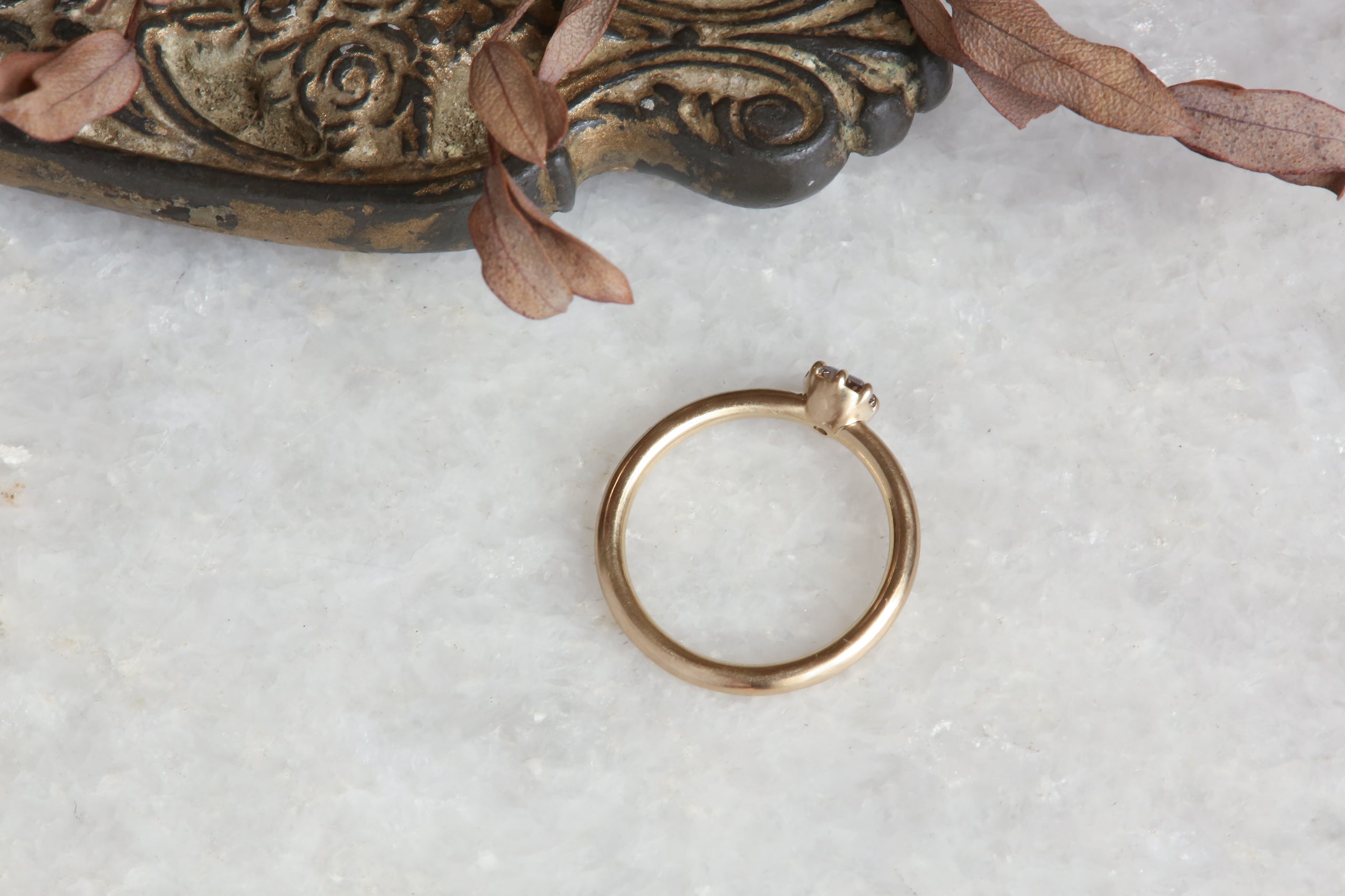 A solitaire ring inspired by antique collet settings in 14 karat yellow gold and natural Montana sapphire