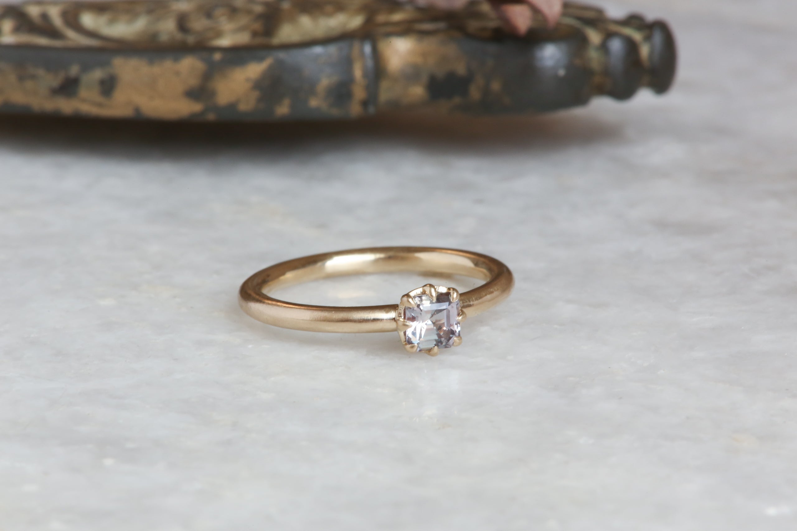 A solitaire ring inspired by antique collet settings in 14 karat yellow gold and natural Montana sapphire