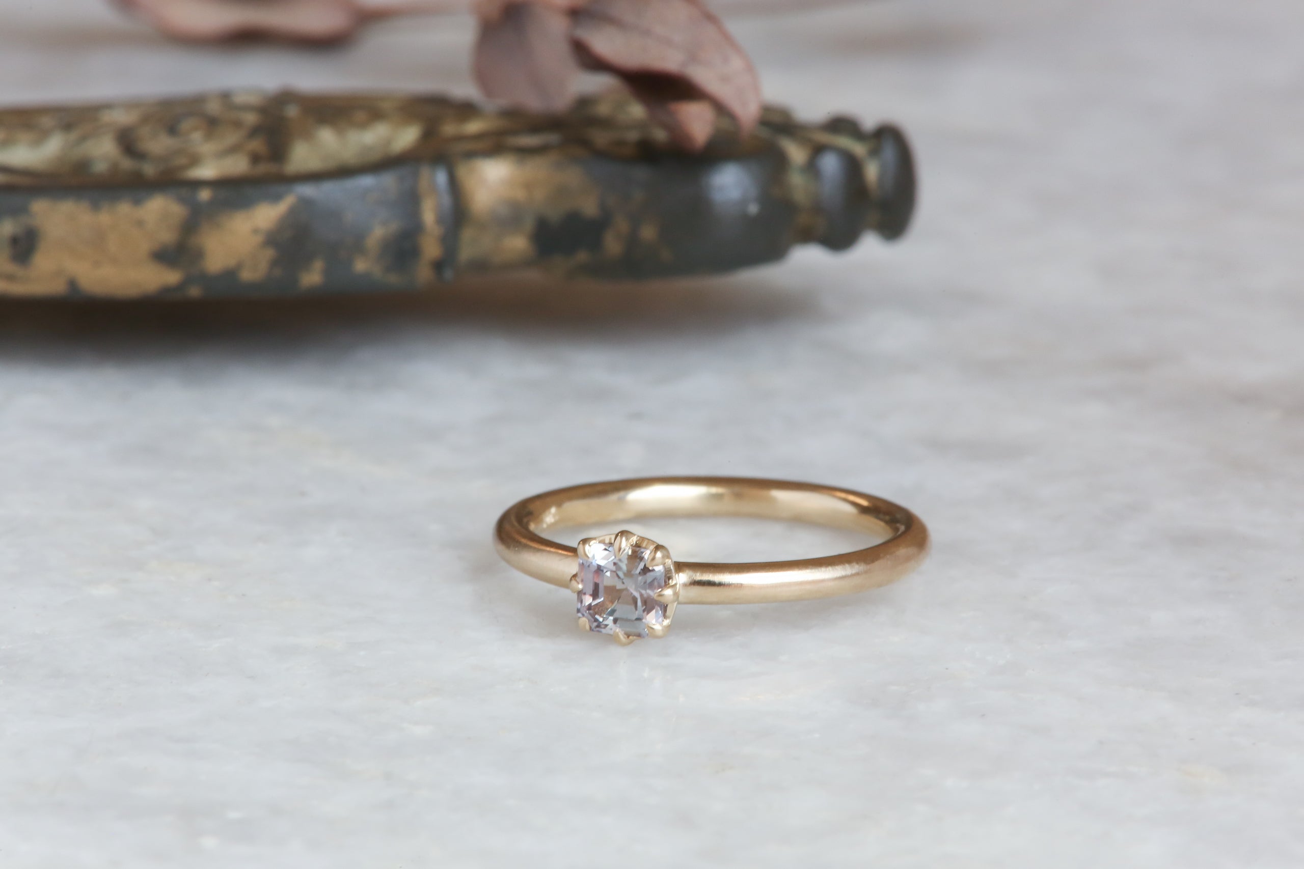 A solitaire ring inspired by antique collet settings in 14 karat yellow gold and natural Montana sapphire