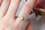 Antique inspired collet setting with natural cushion cut opalescent diamond. Ready to ship solitaire engagement ring in brushed 14 karat yellow gold. 