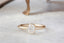 Antique inspired collet setting with natural cushion cut opalescent diamond. 