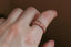 A hand-carved floral signet ring inspired by medieval jewelry and Joan of Arc. Shown in 10 karat rose gold.