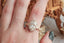 A ready to ship leaf and diamond halo engagement ring in 14 karat yellow gold and lab grown oval diamond
