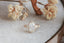 A ready to ship leaf and diamond halo engagement ring in 14 karat yellow gold and lab grown oval diamond