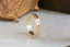 An engraved eternity band with a geometric starburst pattern in 14 karat yellow gold, size 11.