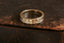 An engraved eternity band with a geometric starburst pattern in 14 karat yellow gold, size 11.