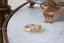 Fantasy inspired lavender flower wide signet band. Ready to ship in 10 karat yellow gold with a soft brushed finish.