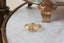 A fantasy inspired wide flower signet band with hand-carved lavender cast in 10 karat yellow gold with a soft brushed finish. A protection lavender signet ring.