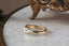 A wide flower signet band with hand-carved lavender shown in 10 karat yellow gold
