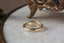 A fantasy inspired wide flower signet band with hand-carved lavender shown in 10 karat yellow gold