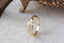 A medieval inspired wide flower signet band with hand-carved lavender shown in 10 karat yellow gold