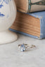 Fae engagement ring in blue sapphire and natural diamond. Three stone ring in white gold with leaf and bark texture.