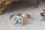 Fantasy elven alternative engagement ring designed and crafted by The North Way Studio. This ready to ship nature inspired engagement ring features a diamond halo, a blue princess cut sapphire center, and hand-carved leaves and vines in reclaimed 18 karat white gold.