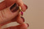 A natural oval ruby Hag Stone pendant in reclaimed 14 karat yellow gold by The North Way Studio. 