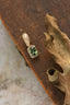The Hag Stone pendant in reclaimed 10 karat yellow gold and .64 carat natural green sapphire. 