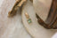 The Hag Stone pendant in reclaimed 10 karat yellow gold and .64 carat natural green sapphire. 