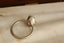An antique-inspired solitaire ring in whittled 14 karat white gold and 3.03 carat oval brilliant cut lab grown diamond by The North Way Studio. Shown in profile. 