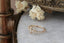 A gold ring by The North Way Studio, featuring a crown of marquise and round white diamonds in a floral pattern on a rustic, bark-textured band. Designed with a vintage-inspired elegance, this piece captures the magic-inspired aesthetic of the studio. Shown facing left.