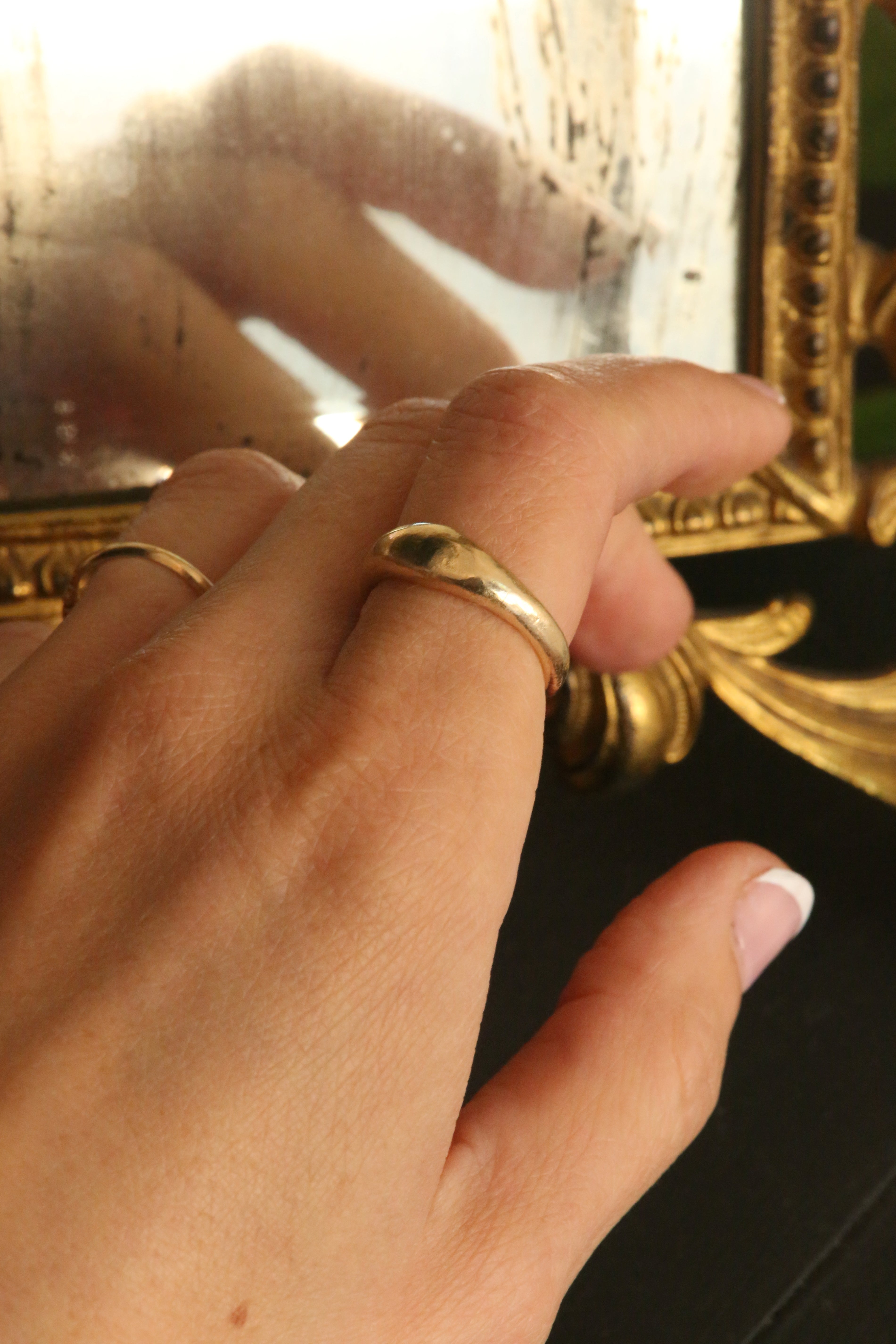 A 14 karat yellow gold signet band with ancient texture. 