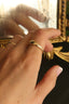 A 14 karat yellow gold signet band with ancient texture. 