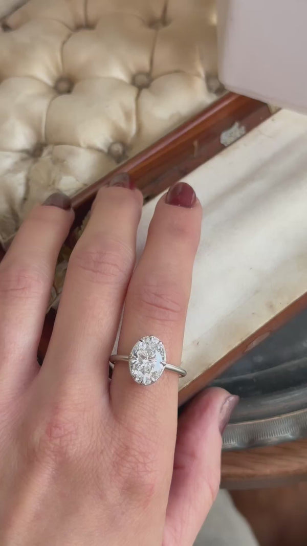 An antique-inspired solitaire ring in whittled 14 karat white gold and 3.03 carat oval brilliant cut lab grown diamond by The North Way Studio. 