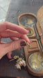 The Hag Stone pendant in reclaimed 10 karat yellow gold and natural green sapphire. 