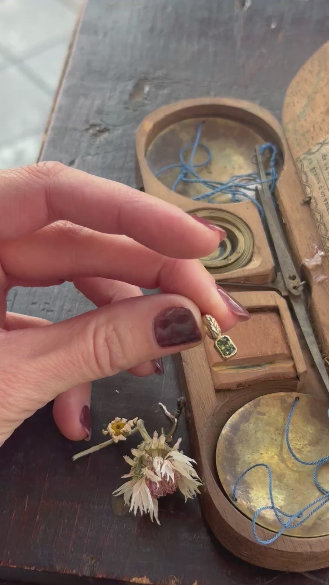 The Hag Stone pendant in reclaimed 10 karat yellow gold and natural green sapphire. 