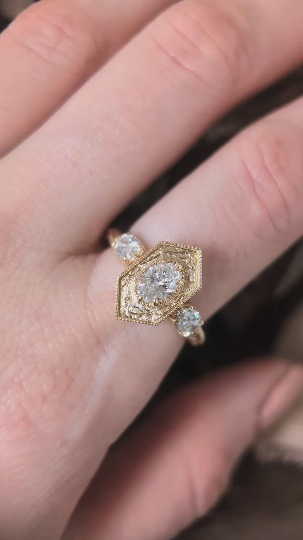 The Hidden Gate En Trois in lab grown oval brilliant cut diamonds shown upon the hand by The North Way Studio. 