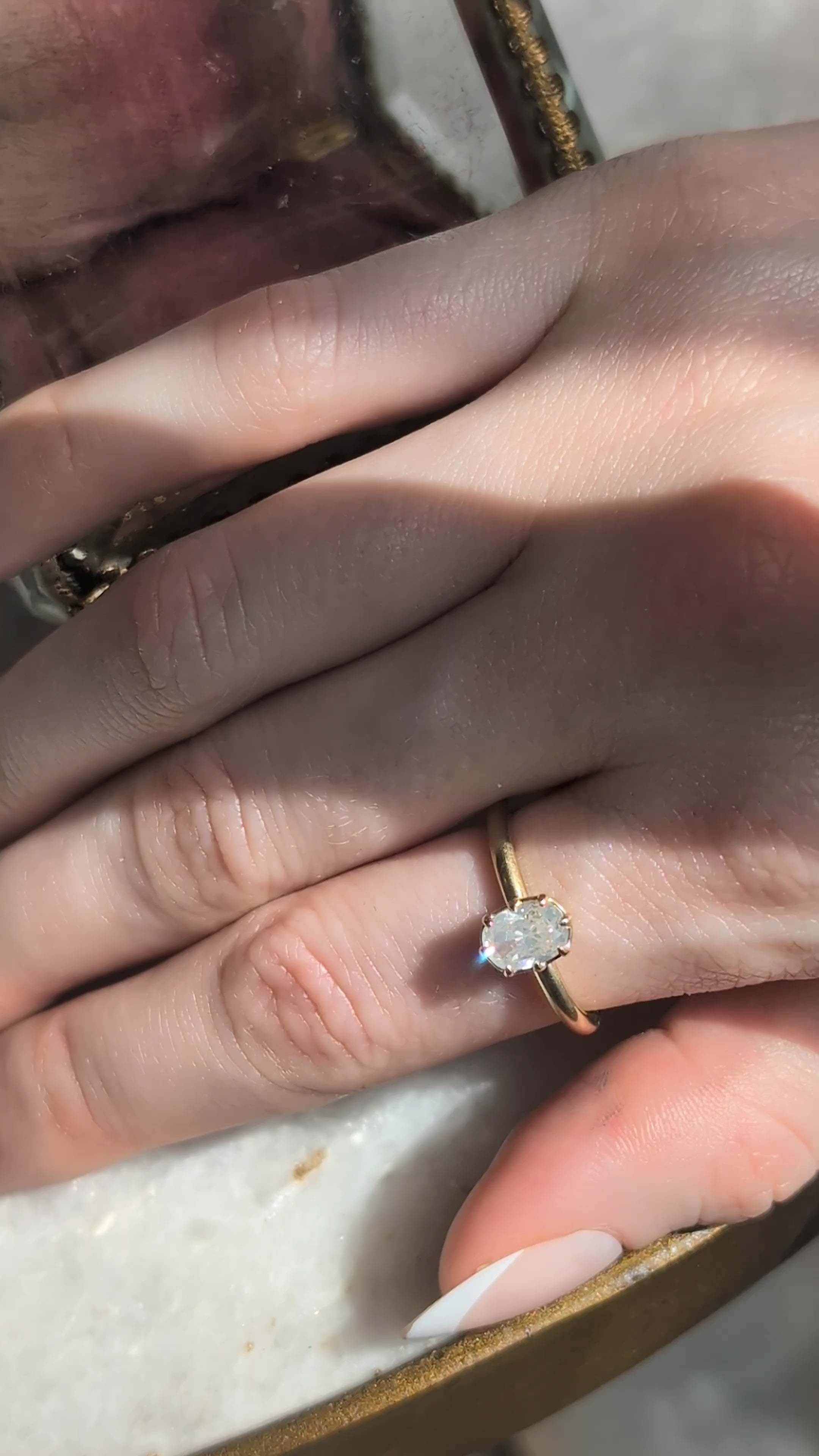 The Iseult Heirloom Setting by The North Way Studio shown upon the hand in yellow gold. 