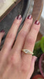 The Spire Signet in reclaimed 18 karat yellow gold and natural marquise cut Canadian diamond center. Set east to west with medieval-inspired leaves. Shown on the hand in a video. 