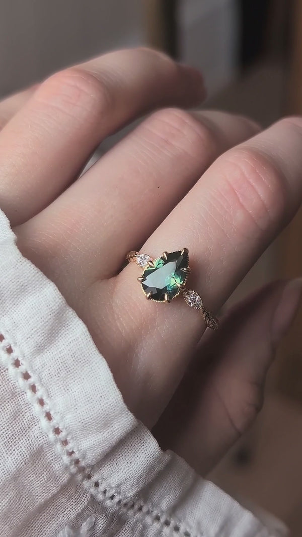 The Solstice Ring Heirloom Setting shown upon the hand with a natural pear cut sapphire and diamond marquise shoulders by The North Way Studio.