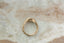 A 14 karat yellow gold ring with opalescent natural diamond in a signet style. 