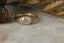 A 14 karat yellow gold ring with opalescent natural diamond in a signet style. 