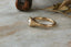 A 14 karat yellow gold ring with opalescent natural diamond in a signet style. 